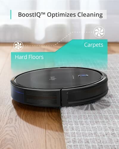 Robot vacuum cleaner transitioning from hard floor to carpet with BoostIQ feature.